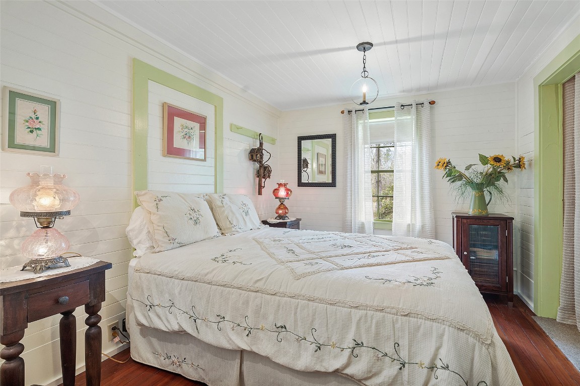 65094 Logan Road Yulee, FL 32097 - Photo 14 of 38 a spacious bedroom with a bed and a chandelier