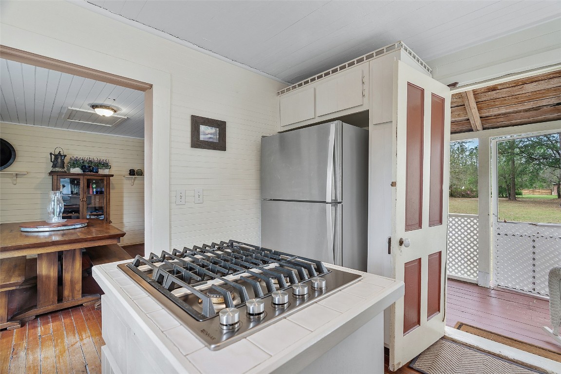 65094 Logan Road Yulee, FL 32097 - Photo 22 of 38 a kitchen with stainless steel appliances granite countertop a refrigerator and a stove