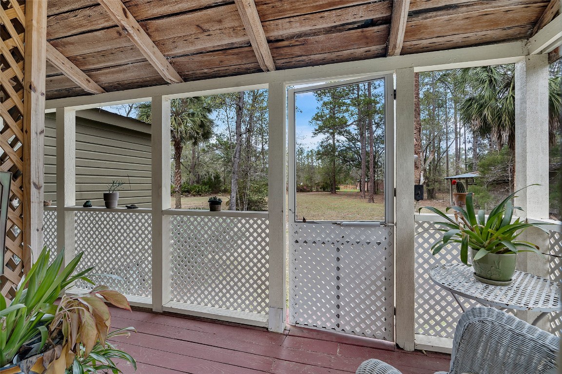 65094 Logan Road Yulee, FL 32097 - Photo 23 of 38 a view of a porch with wooden floor