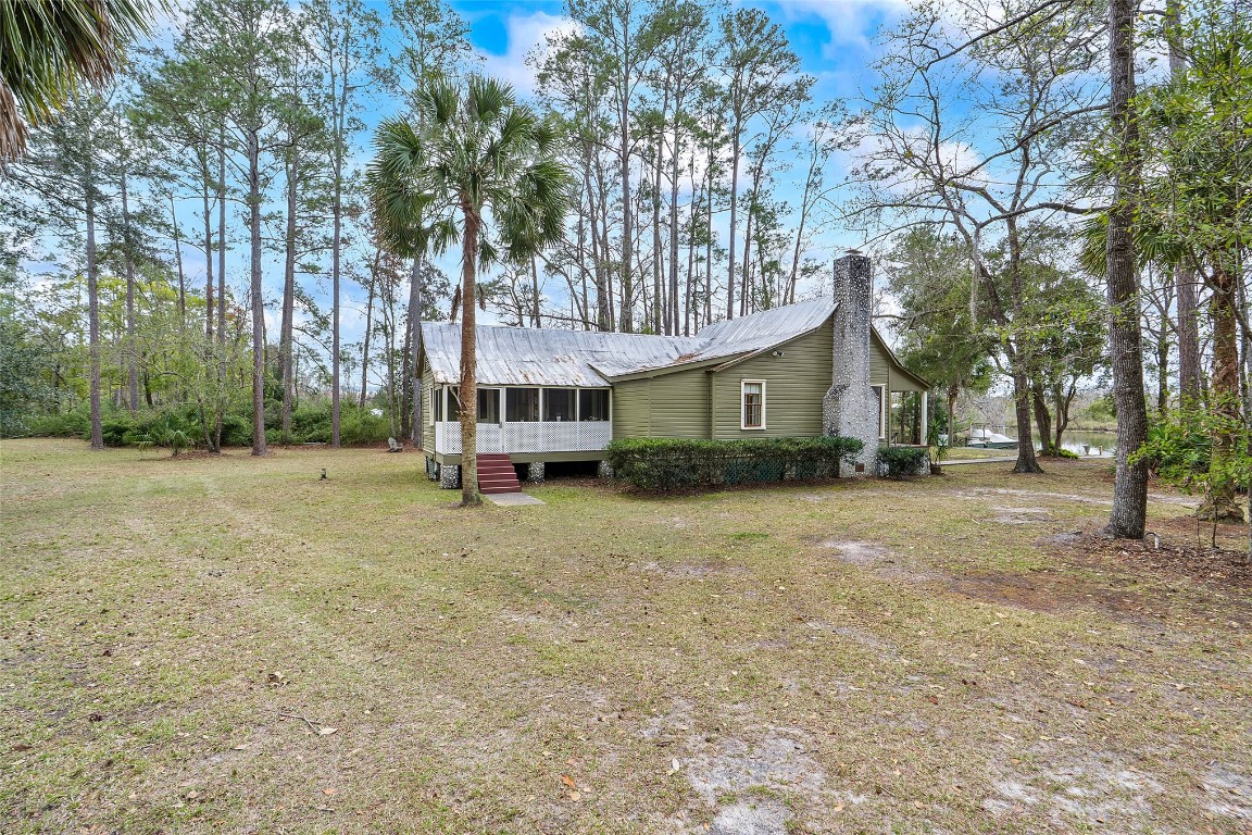 65094 Logan Road Yulee, FL 32097 - Photo 25 of 38 a house with trees in front of it