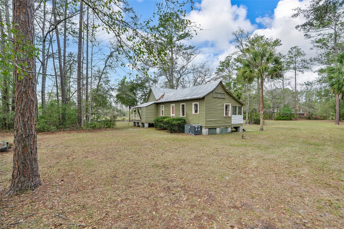 65094 Logan Road Yulee, FL 32097 - Photo 26 of 38 a house with trees in the background