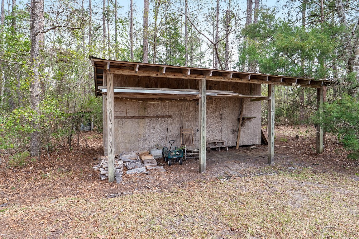 65094 Logan Road Yulee, FL 32097 - Photo 37 of 38 a backyard of a house with table and chairs