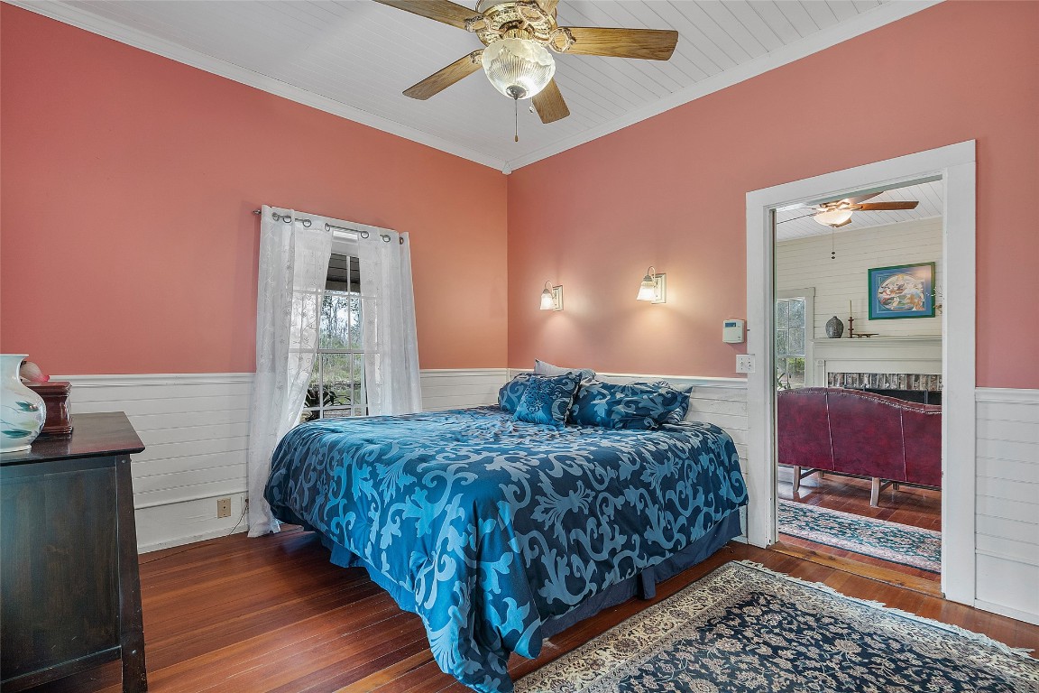 65094 Logan Road Yulee, FL 32097 - Photo 9 of 38 a bedroom with a bed and a chandelier