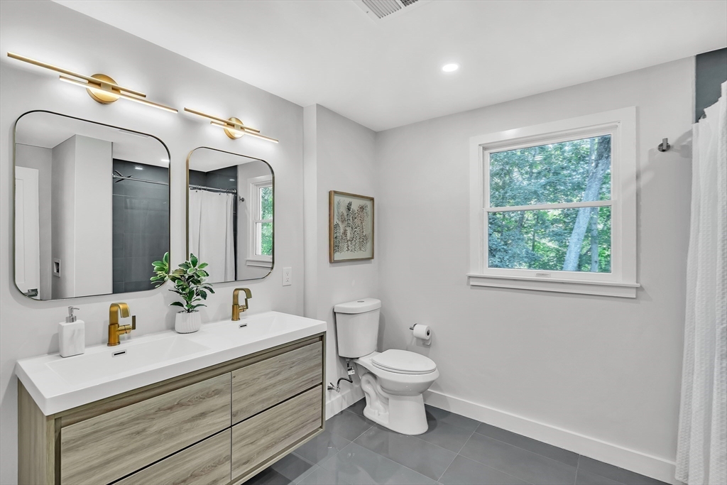 95 Country Club Road Dedham, MA 02026 - Photo 16 of 21 a bathroom with a toilet sink and mirror