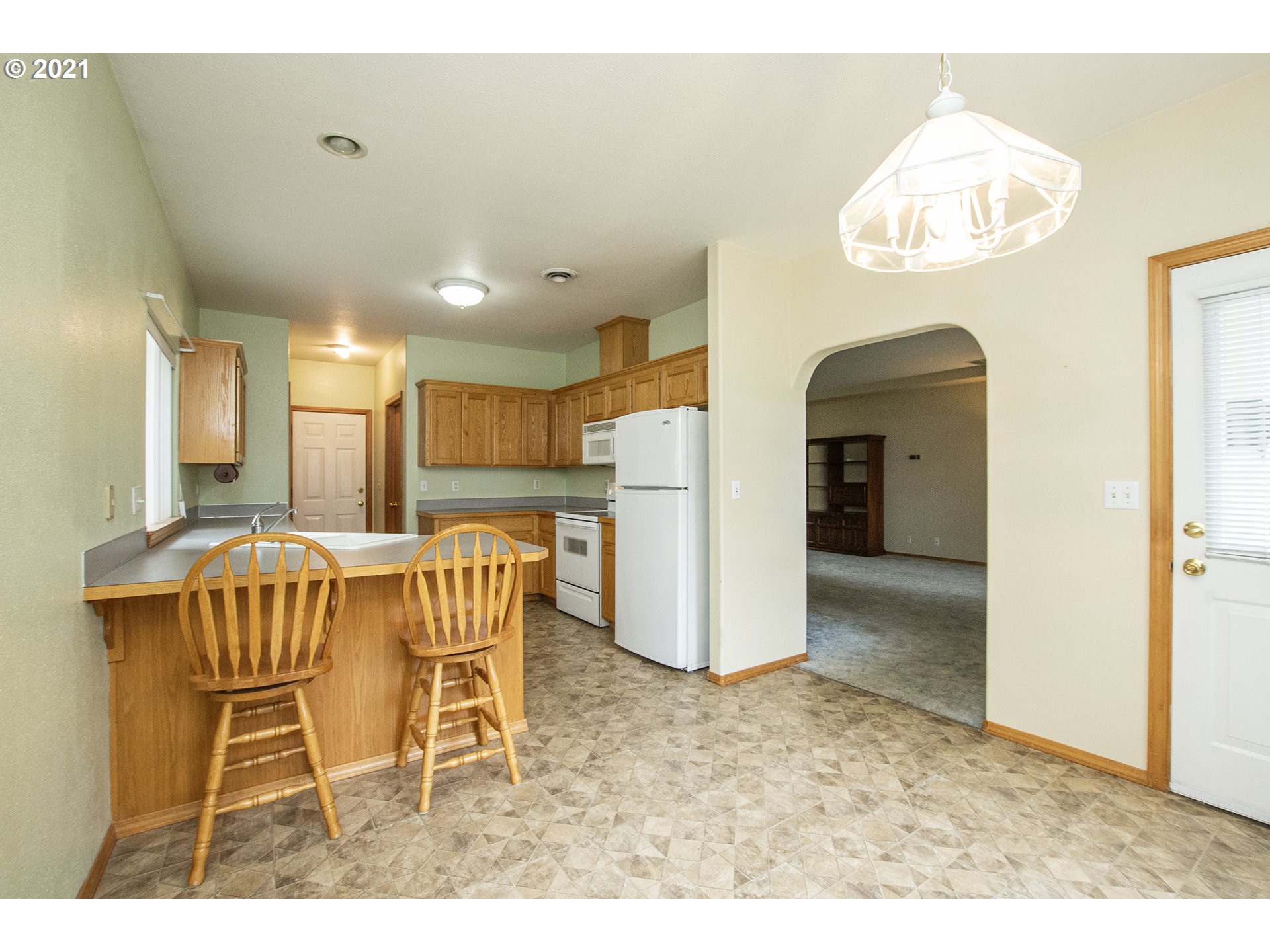 4142 South E Street Springfield, OR 97478 - Photo 12 of 26 a view of a dining room with furniture and a chandelier
