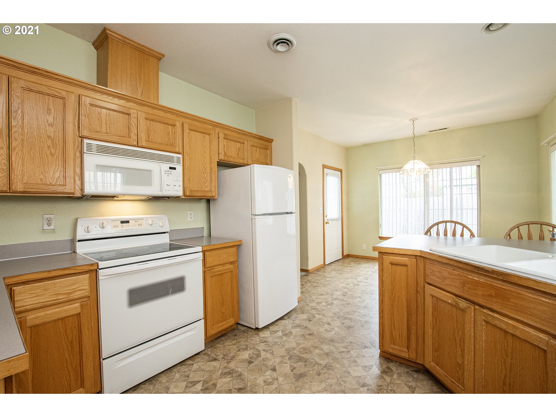 4142 South E Street Springfield, OR 97478 - Photo 9 of 26 a kitchen with a refrigerator sink stove and cabinets