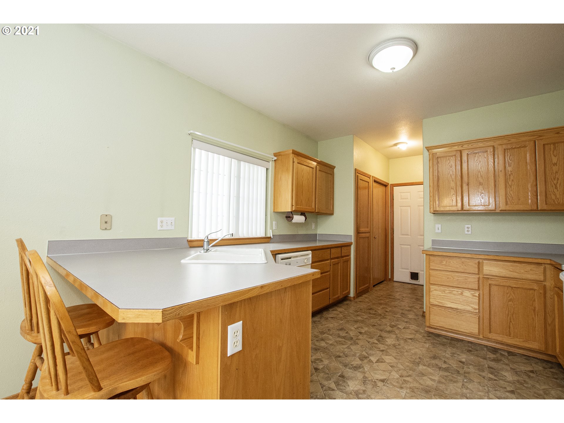 4142 South E Street Springfield, OR 97478 - Photo 10 of 26 a kitchen with stainless steel appliances granite countertop a sink and a white cabinets