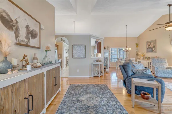 a living room with furniture and a dining table