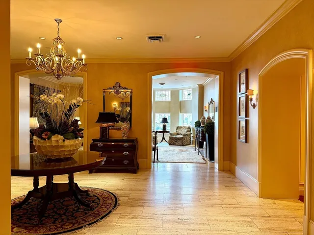 a living room with furniture and a chandelier