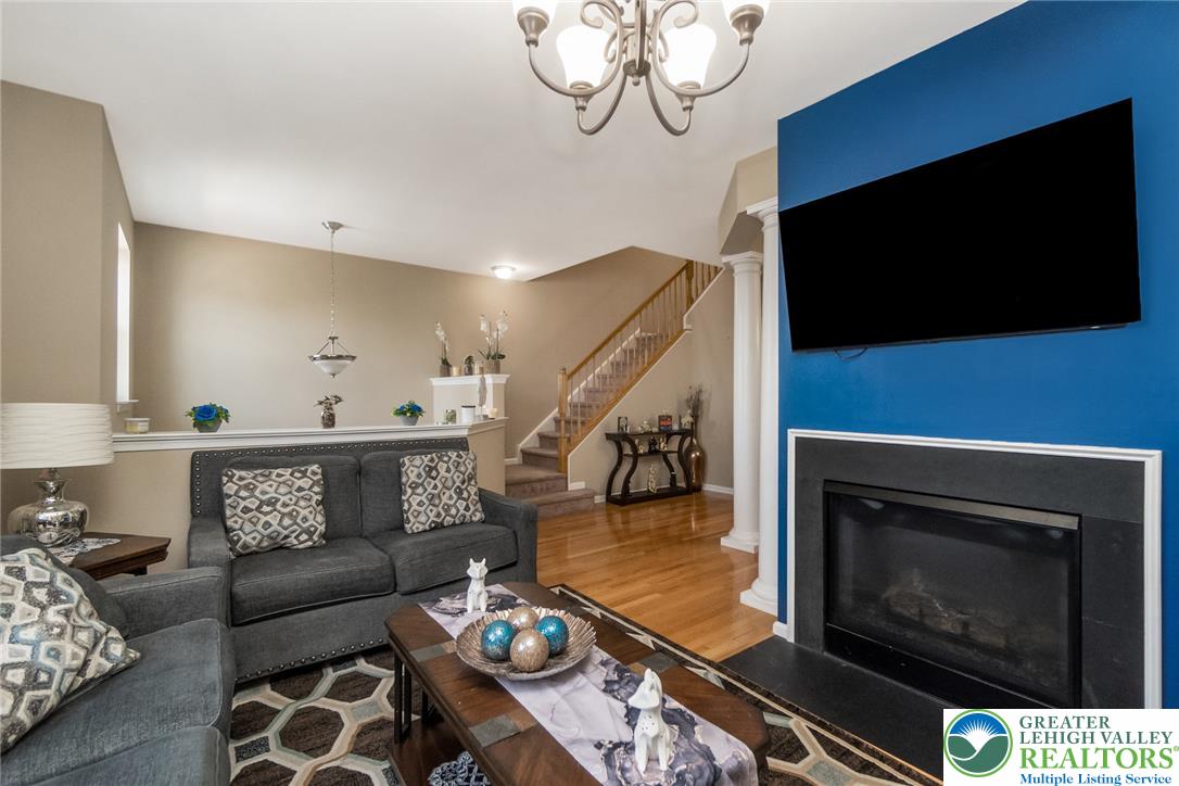 3566 Penfield Way Nazareth, PA 18064 - Photo 23 of 47 Warm hardwood floors extend across the open living area, highlighted by a contemporary fireplace feature wall.