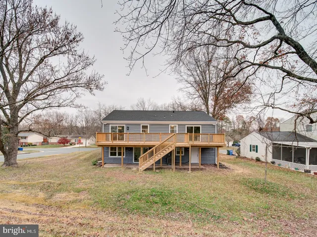 a view of a house with a yard in front of it