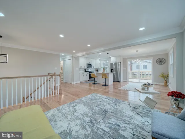 a view of a hallway with dining room and wooden floor