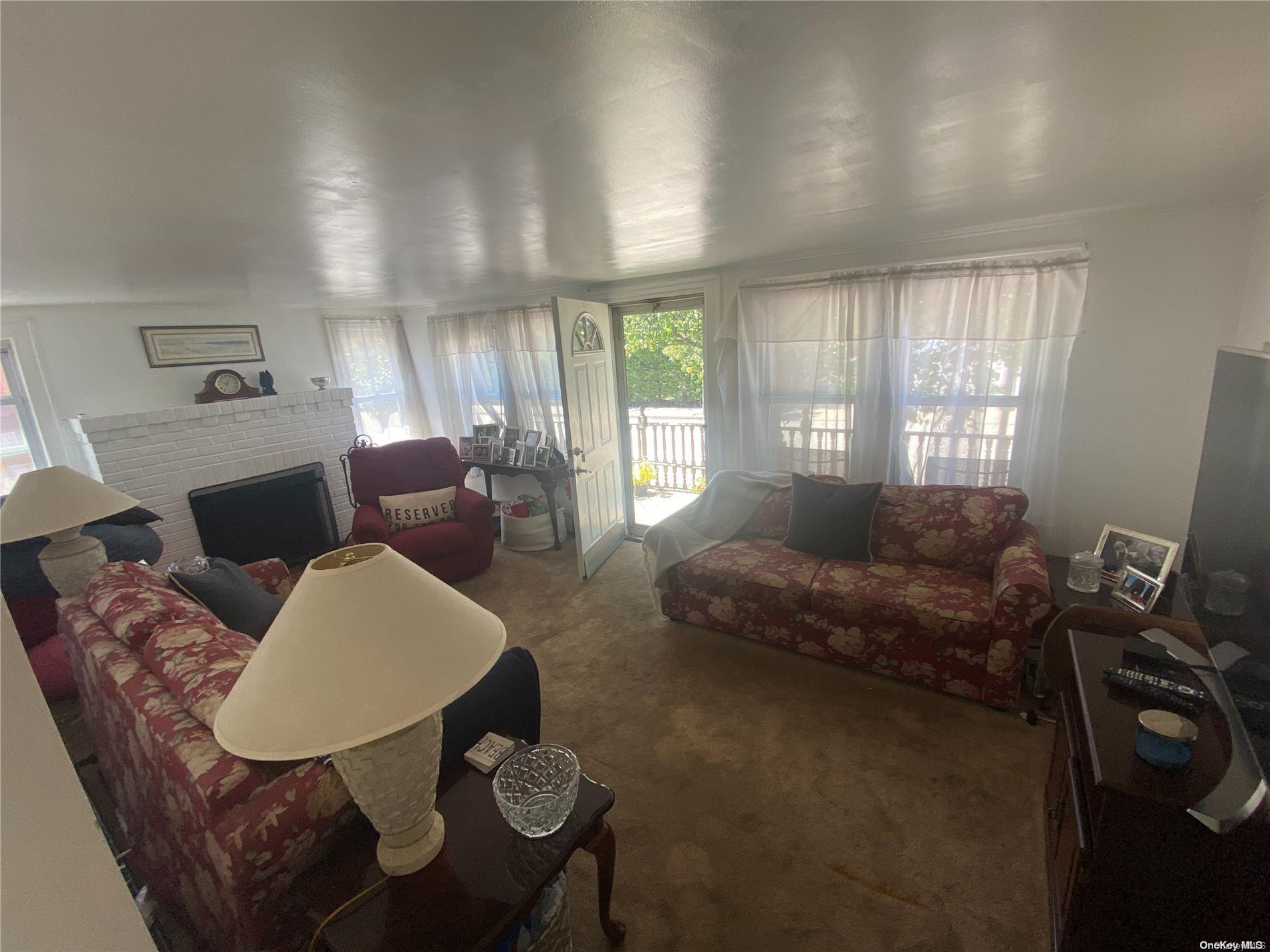 68 Parkside Drive Point Lookout, NY 11569 - Photo 8 of 17 a living room with furniture and a large window