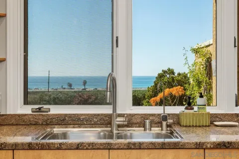 a balcony with furniture and a floor to ceiling window