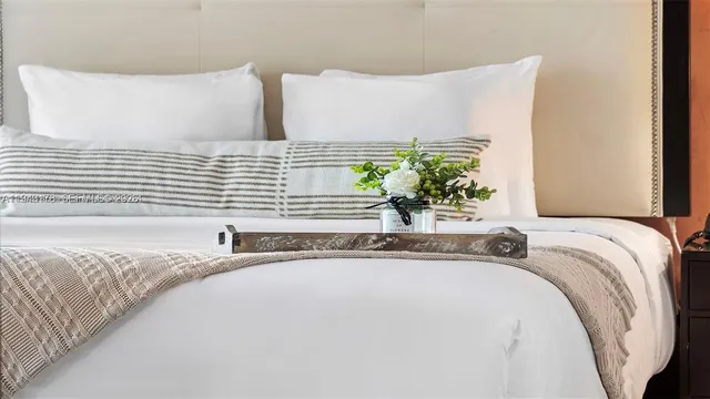 a bathroom with a granite countertop sink and a bathtub