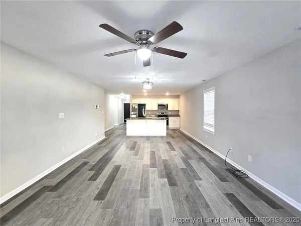 a kitchen with stainless steel appliances a sink a stove a microwave a refrigerator a sink and cabinets