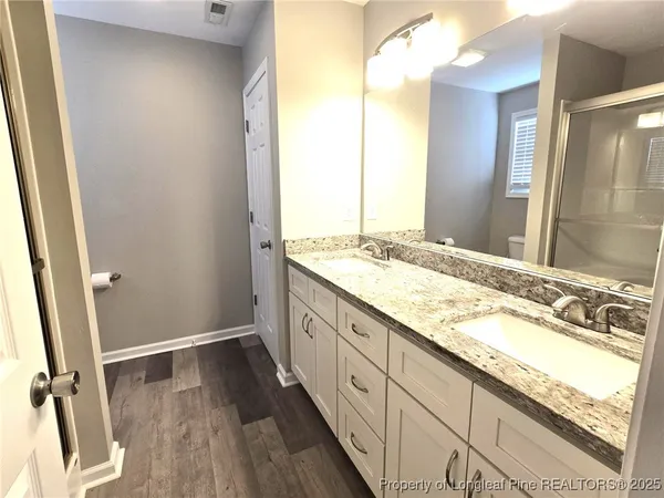 a bathroom with a glass shower door