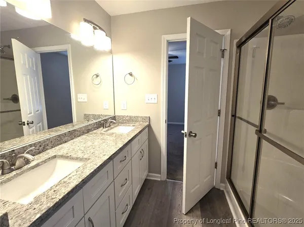 a view of a kitchen with wooden floor and a sink