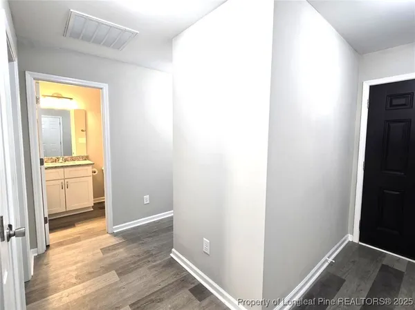 a bathroom with a granite countertop toilet sink and mirror