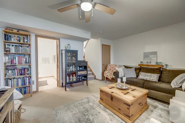a living room with furniture a book shelf and a bookshelf