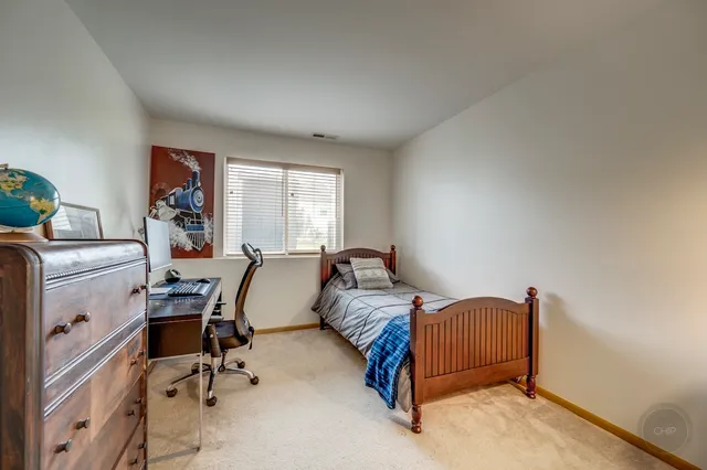 a bed room with a bed and a chair