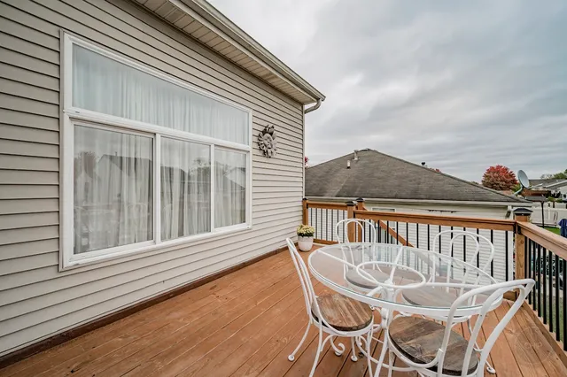 a view of a chair and table on the deck