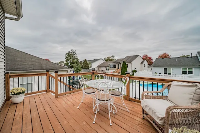 a view of a balcony with wooden floor and outdoor seating