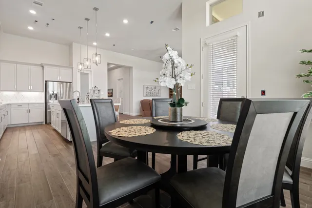 a view of a dining room with furniture and wooden floor
