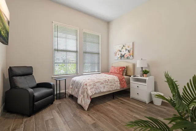 a bedroom with a bed and a couch