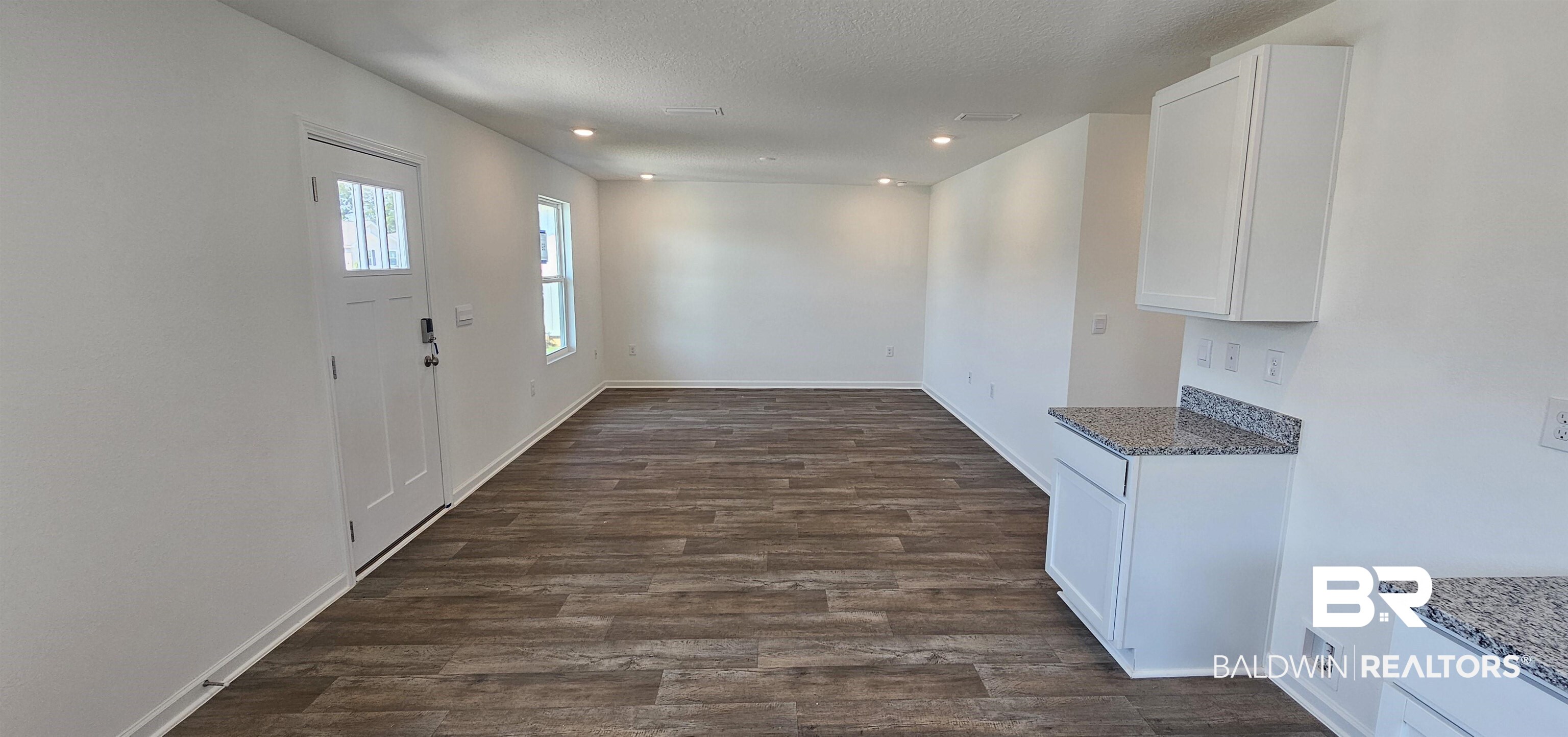 1152 Sweet Laurel Street Foley, AL 36535 - Photo 4 of 4 Foyer entrance featuring dark wood-type flooring and a textured ceiling