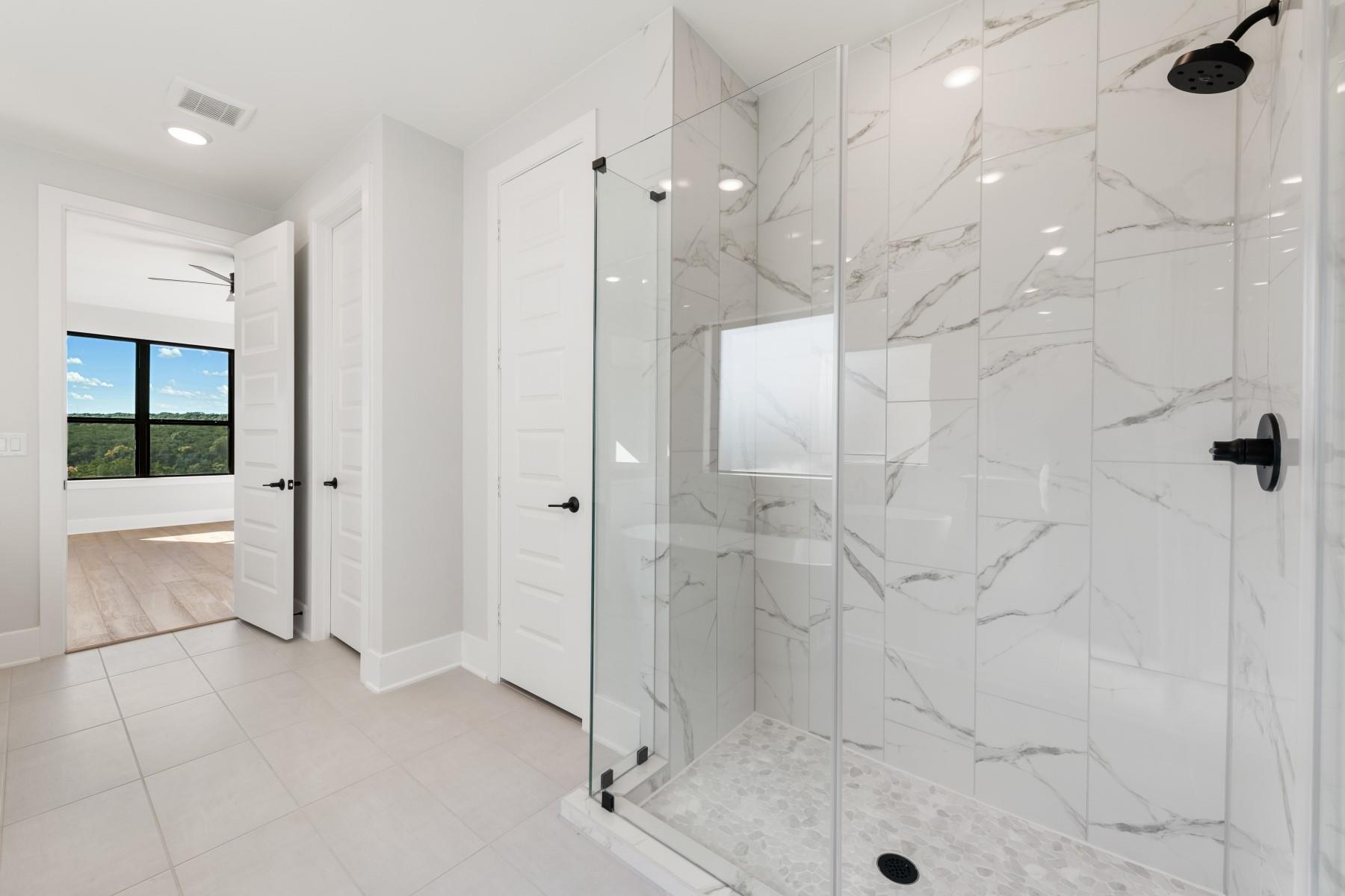 6216 Bower Well Road Austin, TX 78738 - Photo 19 of 31 a bathroom with a shower and a bathtub
