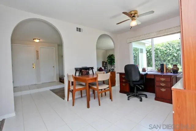 a view of a livingroom with workspace and a window