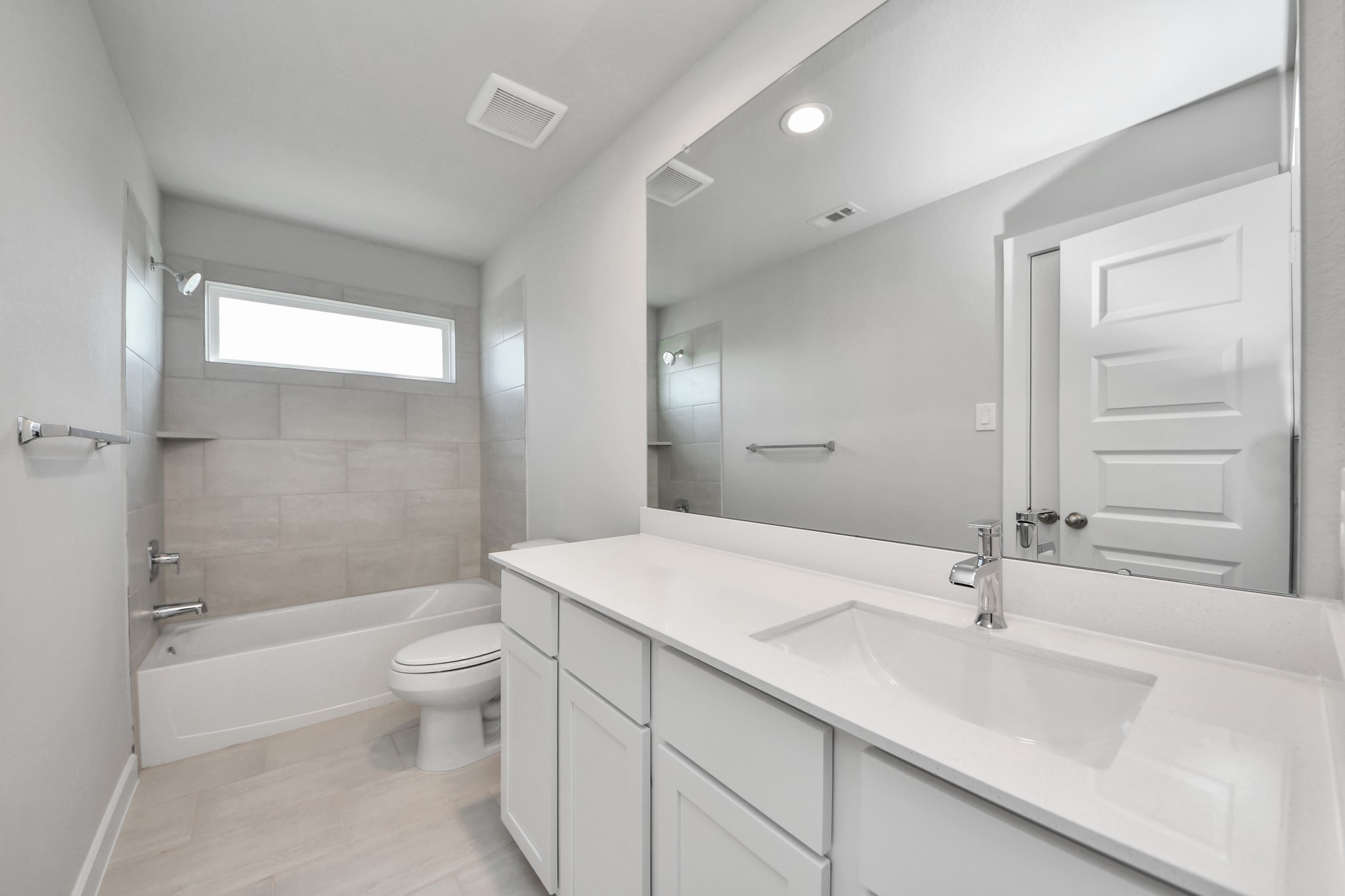2926 Bury Park Dr Spring Spring, TX 77373 - Photo 33 of 38 Secondary bath features tile flooring, bath/shower combo with tile surround, light stained wood cabinets, beautiful light countertop. Sample photo of completed home with similar floor plan. Actual colors and selections may vary.