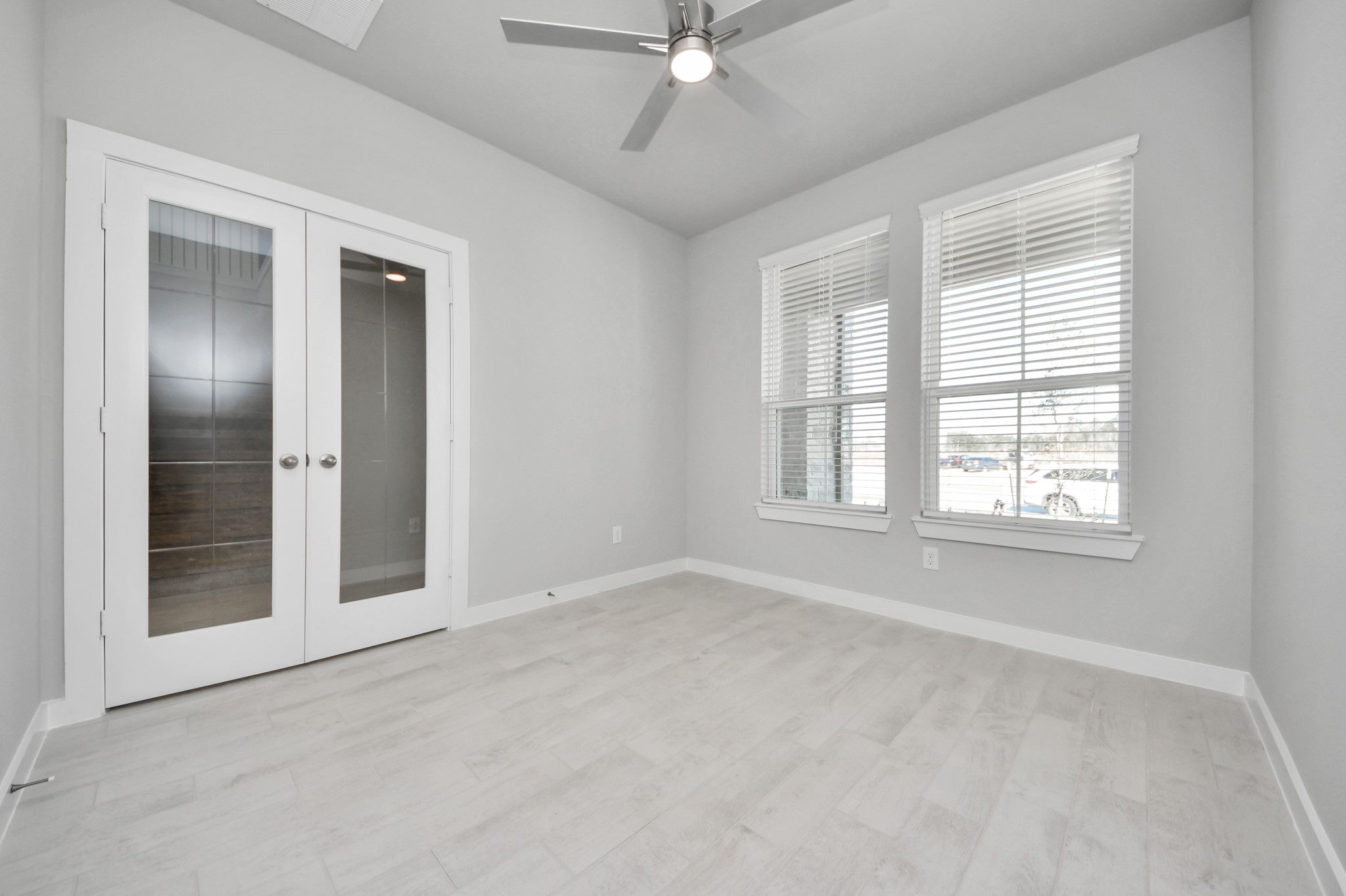2926 Bury Park Dr Spring Spring, TX 77373 - Photo 5 of 38 Step into the inviting home office, where elegant tile flooring adds a touch of freshness and comfort to the workspace. Natural light pours through the window, creating an inspiring environment for productivity and focus. Sample photo of completed home with similar floor plan. Actual colors and selections may vary.