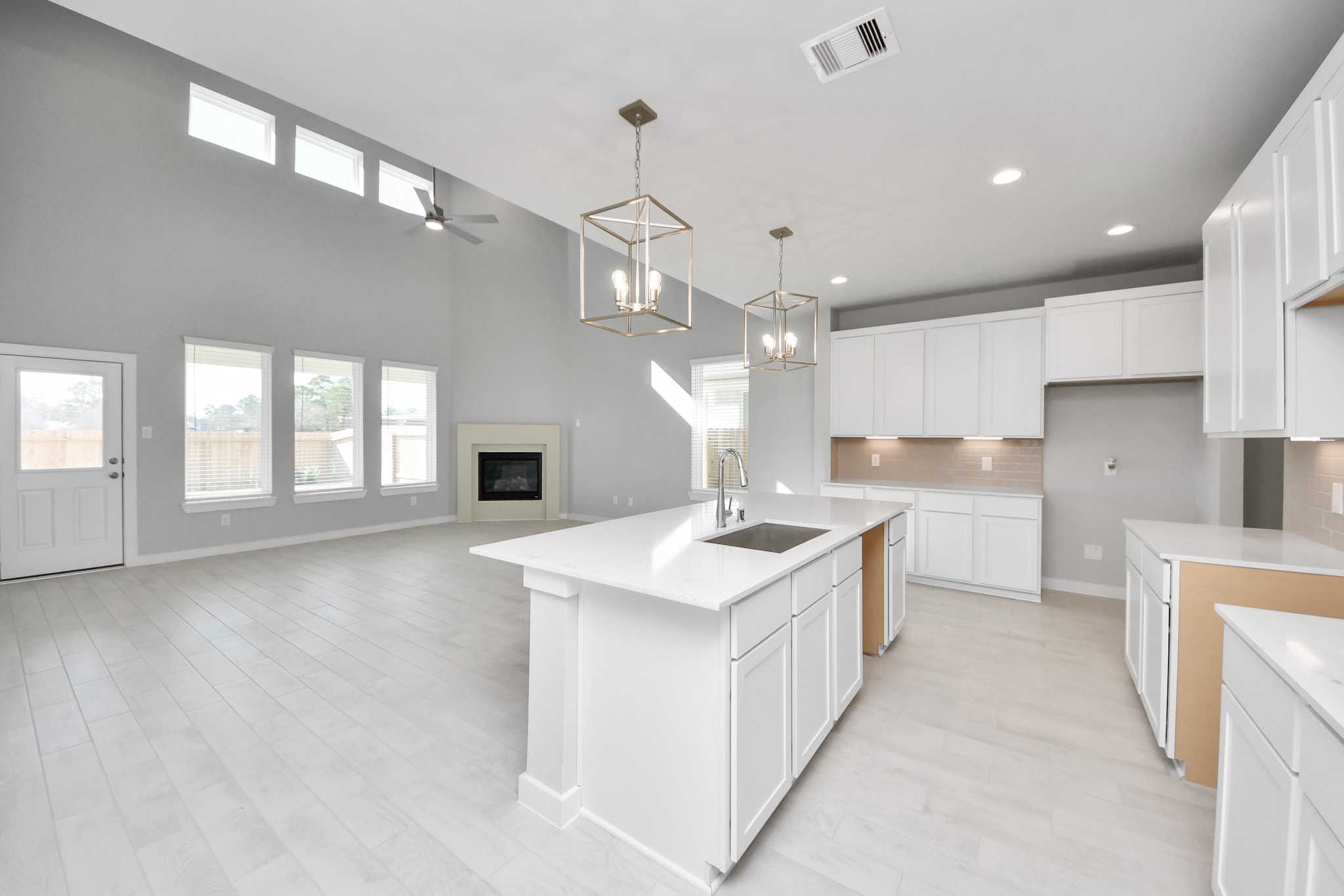 2926 Bury Park Dr Spring Spring, TX 77373 - Photo 10 of 38 The kitchen is a culinary haven, featuring granite countertops, a tile backsplash, stainless steel appliances, 42” upper cabinets, and undercabinet lighting. Sample photo of completed home with similar floor plan. Actual colors and selections may vary.