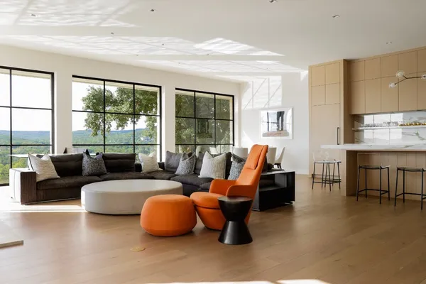 a living room with furniture tv and a large window