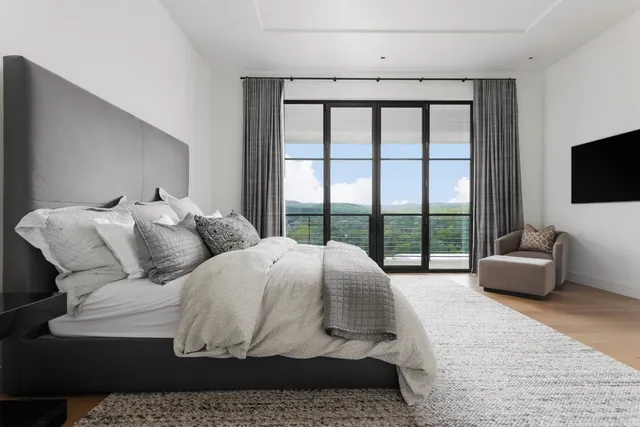 a large white kitchen with kitchen island a sink stainless steel appliances and cabinets