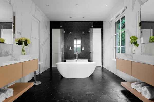 a en suite bathroom with a granite countertop sink and a mirror