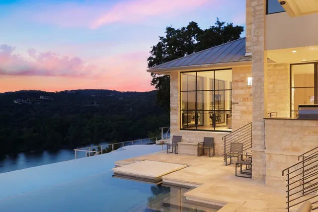 a view of a patio with couches table and chairs and potted plants