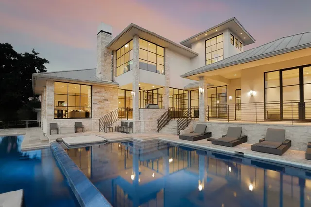 a swimming pool view with a outdoor seating