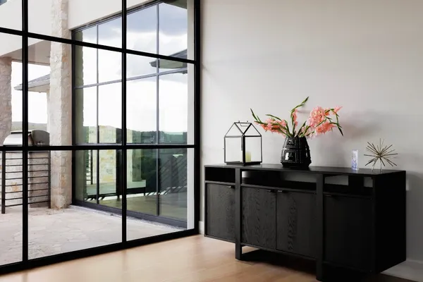 a bedroom with a bed and glass door