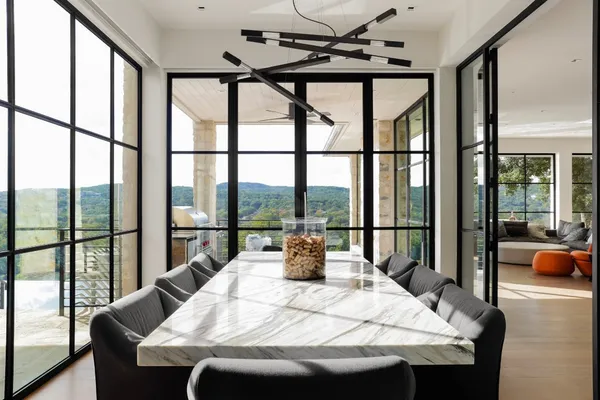 a kitchen with stainless steel appliances granite countertop a sink a stove and a wooden cabinets