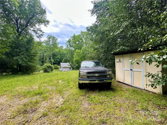 a car parked in front of a house with a small yard