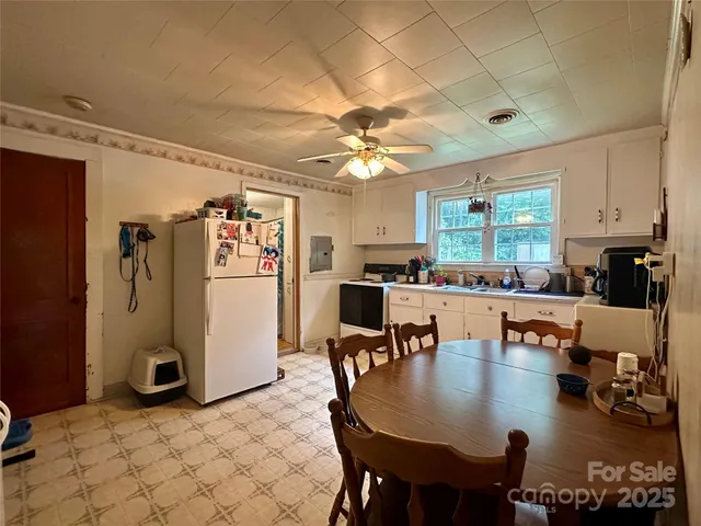 a dining room with furniture and kitchen view