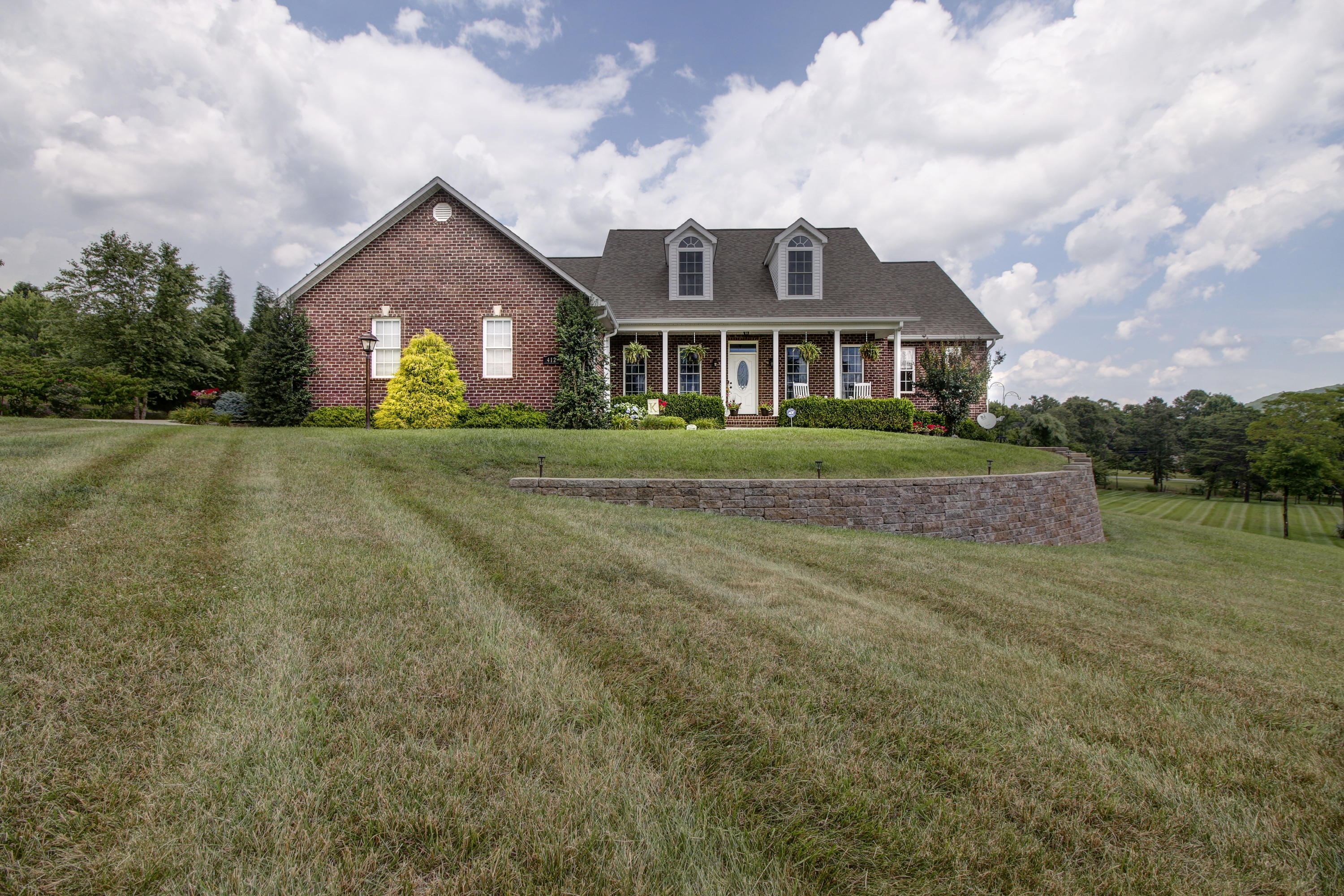 412 Thornblade Way Blue Ridge, VA 24064 - Photo 1 of 47 a front view of a house with garden