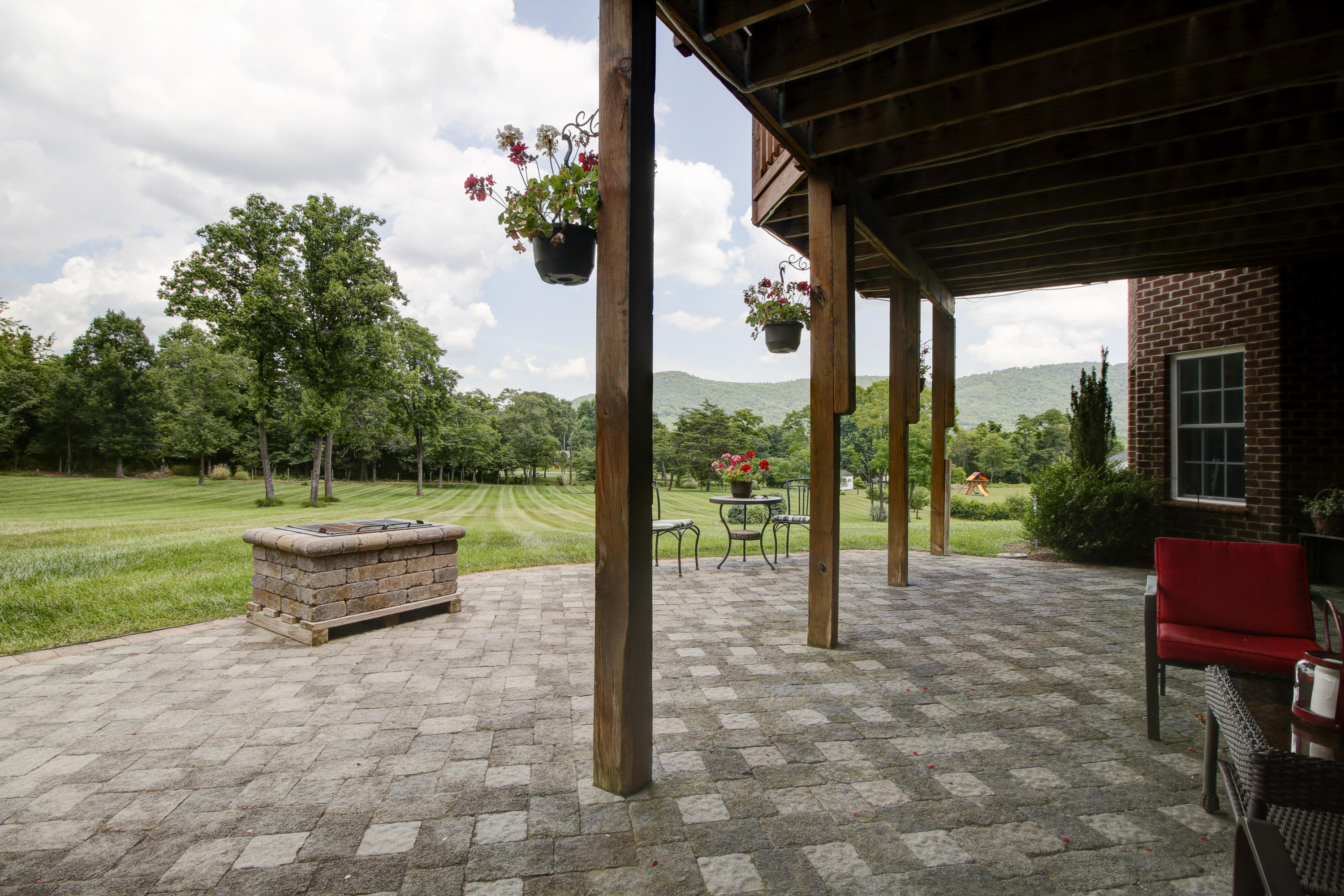 412 Thornblade Way Blue Ridge, VA 24064 - Photo 37 of 47 a view of a patio with table and chairs potted plants with wooden floor and fence