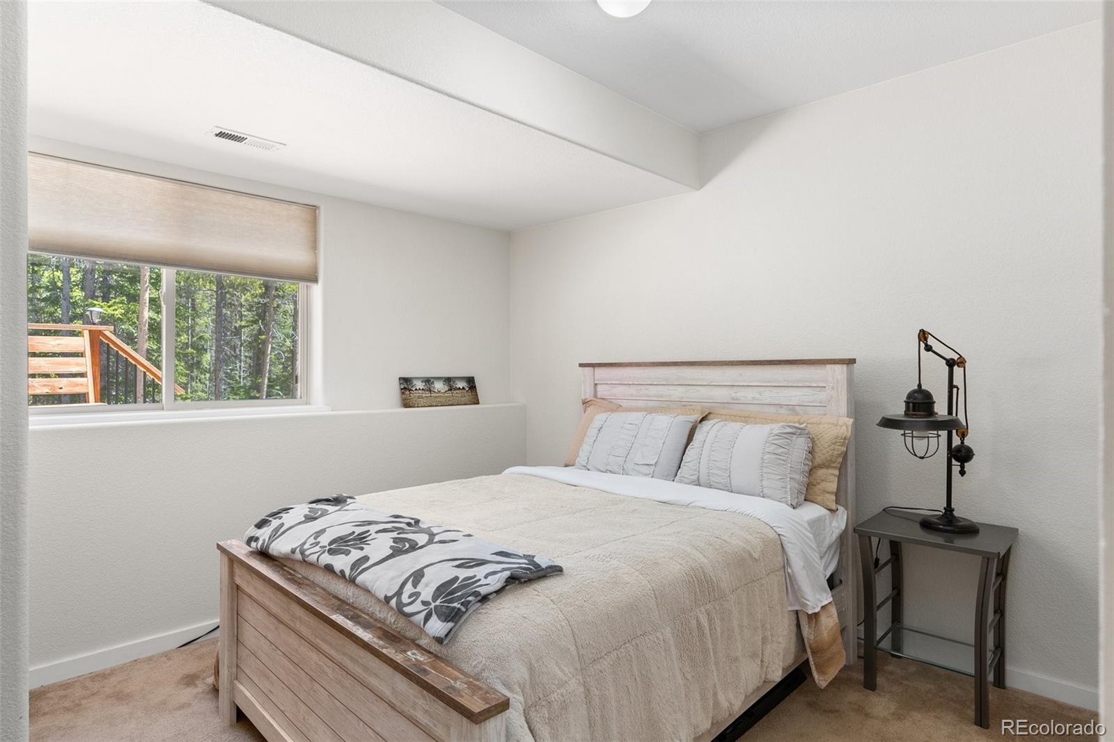 400 Upper Forest Road Idaho Springs, CO 80452 - Photo 12 of 20 a bedroom with a bed and a window