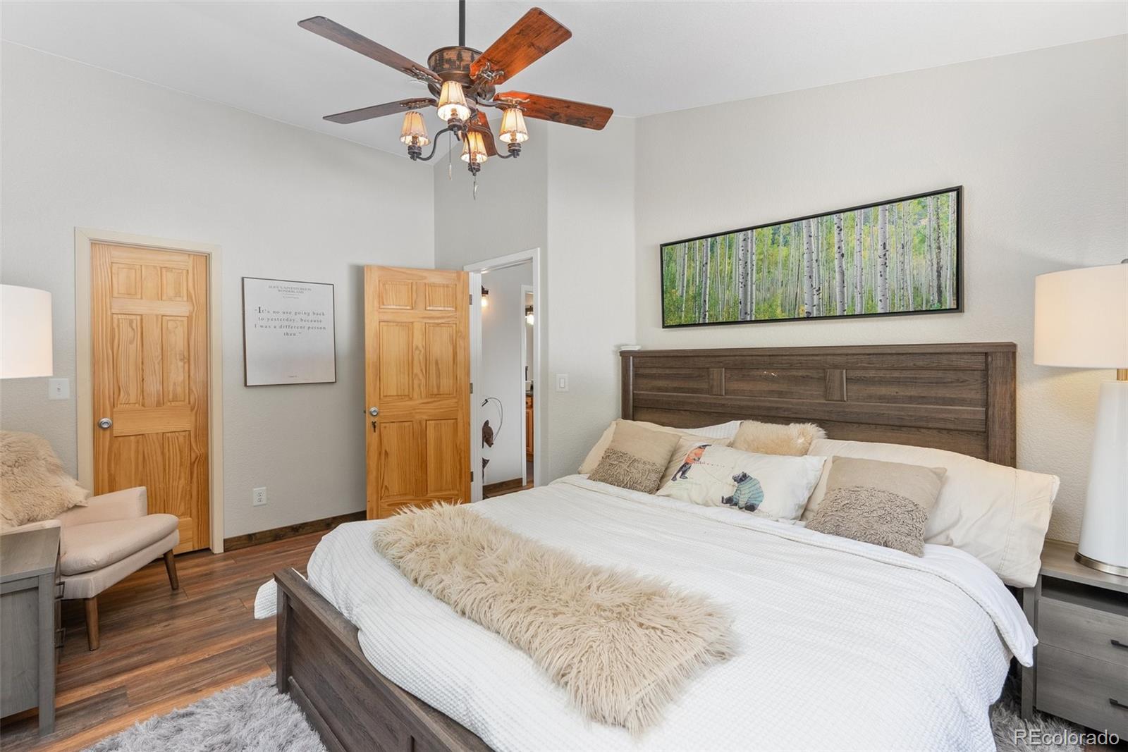 400 Upper Forest Road Idaho Springs, CO 80452 - Photo 7 of 20 a bedroom with a bed and a chandelier
