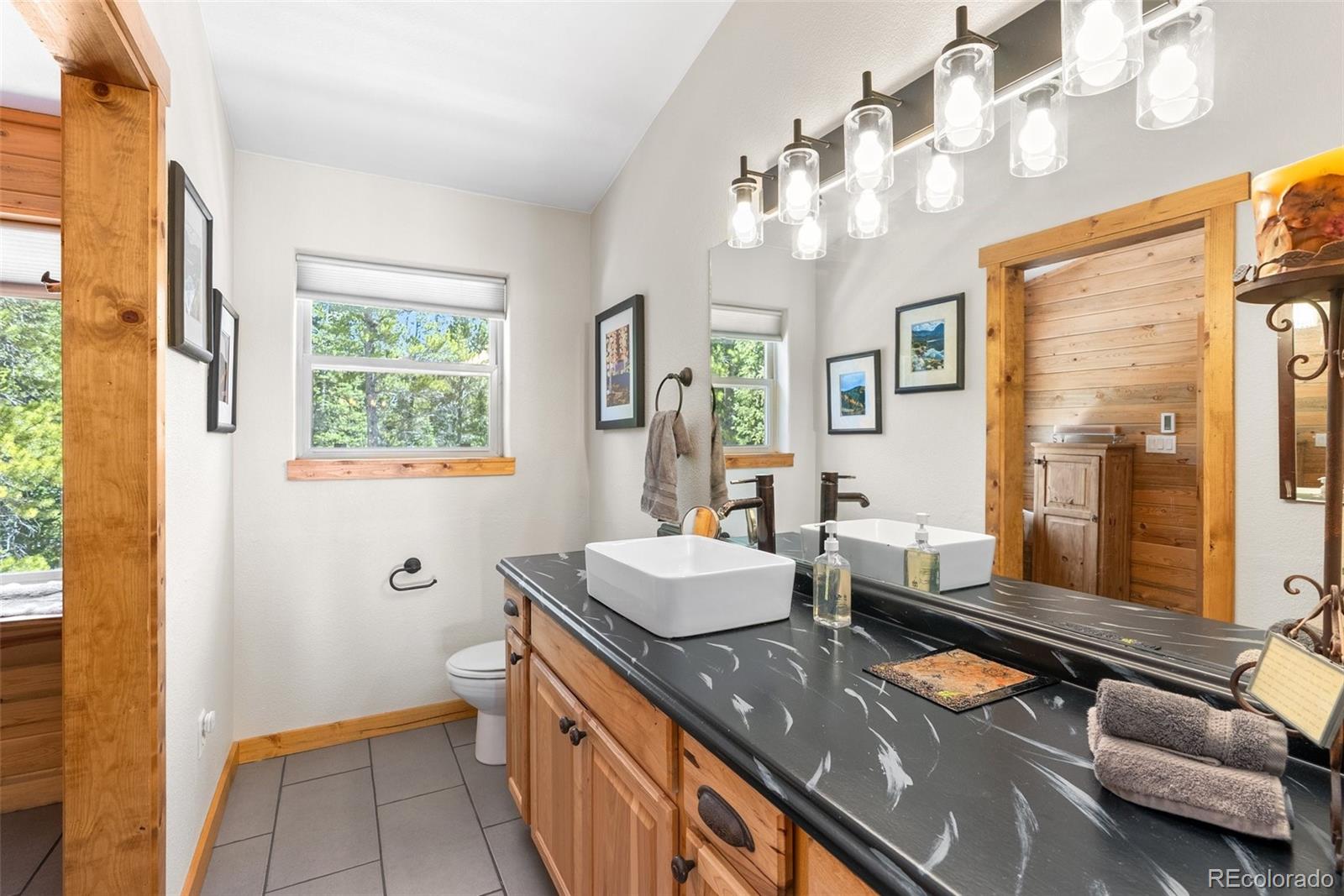 400 Upper Forest Road Idaho Springs, CO 80452 - Photo 8 of 20 a room with stainless steel appliances a chandelier open kitchen view