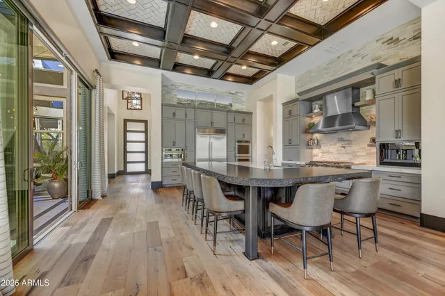 a kitchen with stainless steel appliances granite countertop a stove a sink and a refrigerator